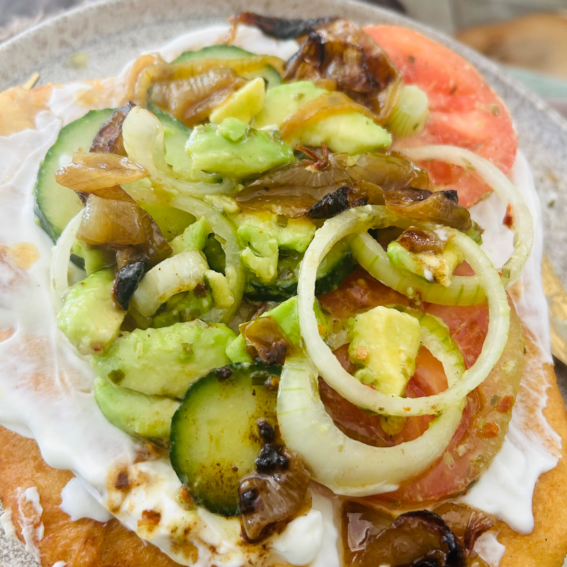 Caramelised onions spooned over the salad on the lángos