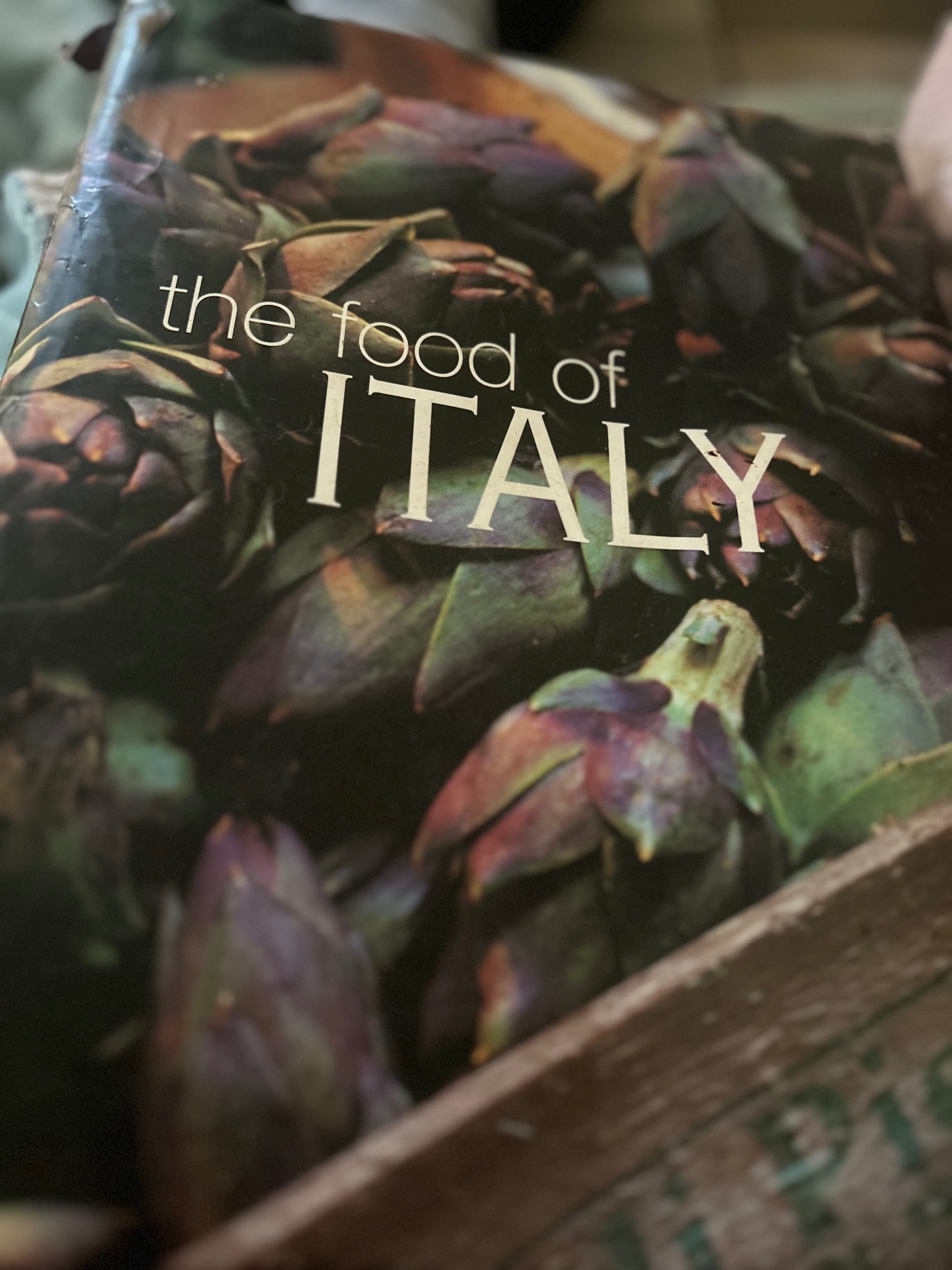 The Food of Italy cookbook by Sophie Braimbridge and Jo Glyn — cover shows a crate of purple globe artichokes