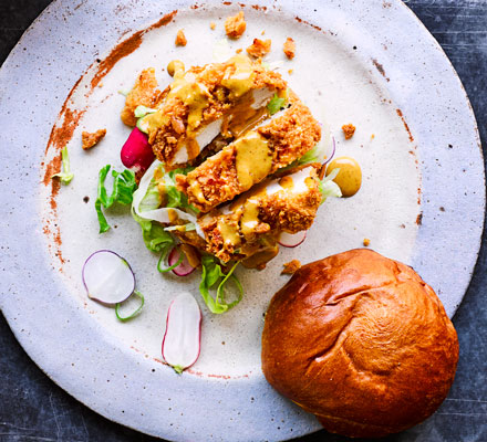 Chicken katsu curry burger — panko-fried chicken in a toasted brioche bun with katsu mayo, lettuce and radishes