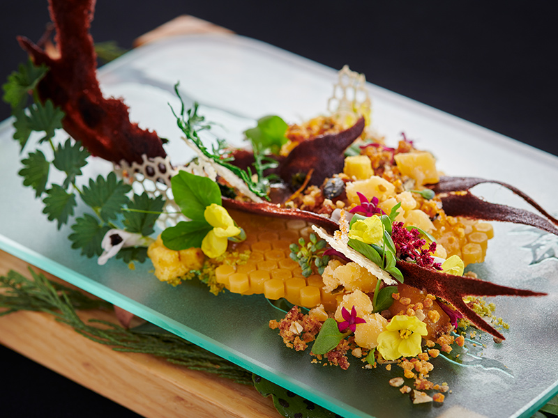An intricate botanical dish by Chantel Dartnall with flowers, herbs and colourful seasonal ingredients