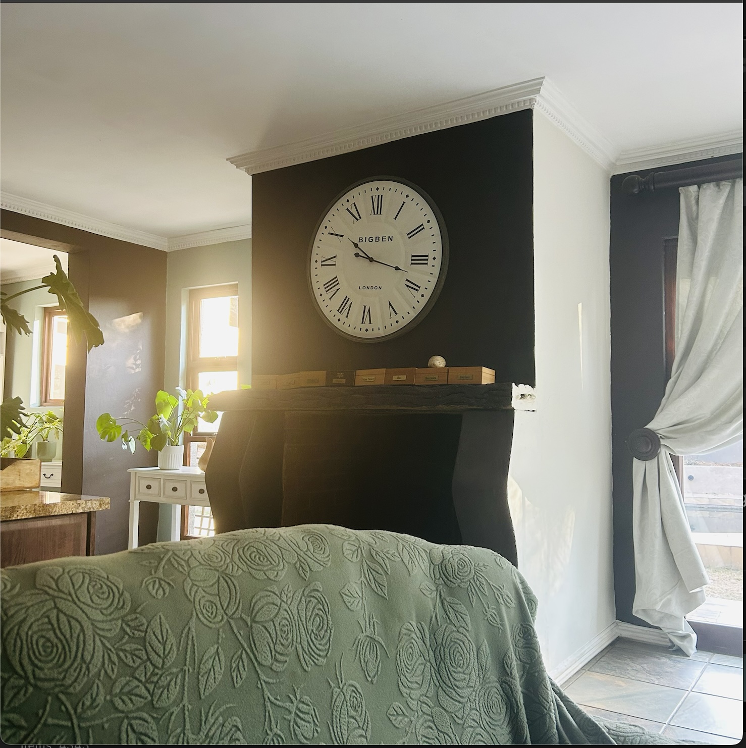 Inky black fireplace wall with oversized Big Ben Roman numeral clock