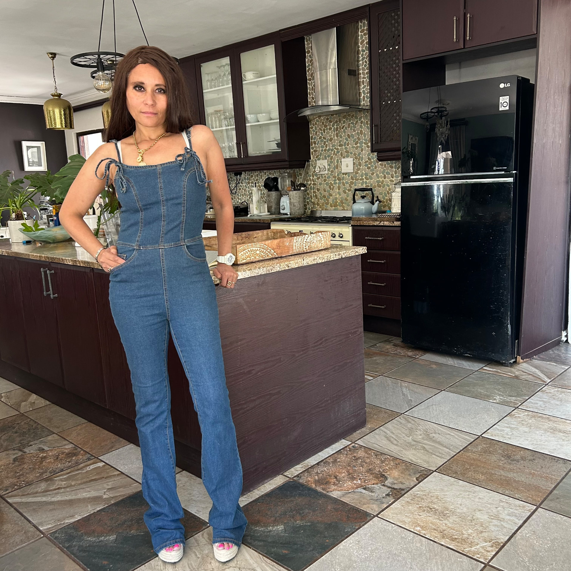 Full length view of Cass in the denim jumpsuit and espadrille wedges