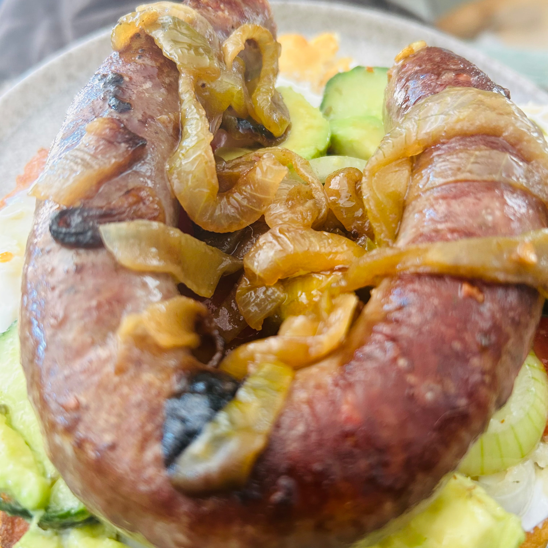 Browned boerewors coiled with caramelised onions