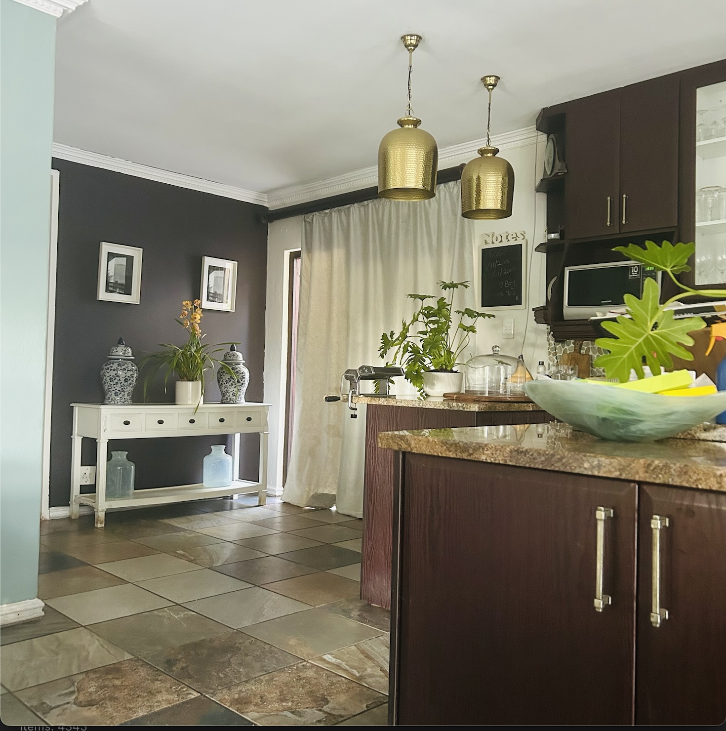 After — inky walls, slate floor and gold hanging pendant shades in the New York scheme