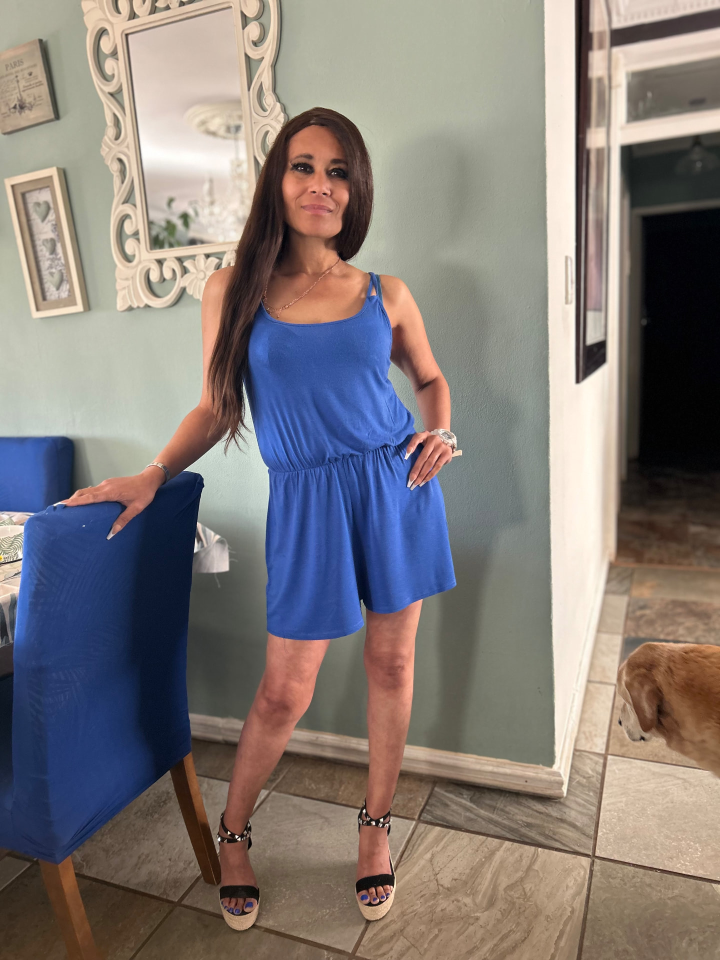 Cass smiling in a cobalt blue playsuit with studded espadrille wedges