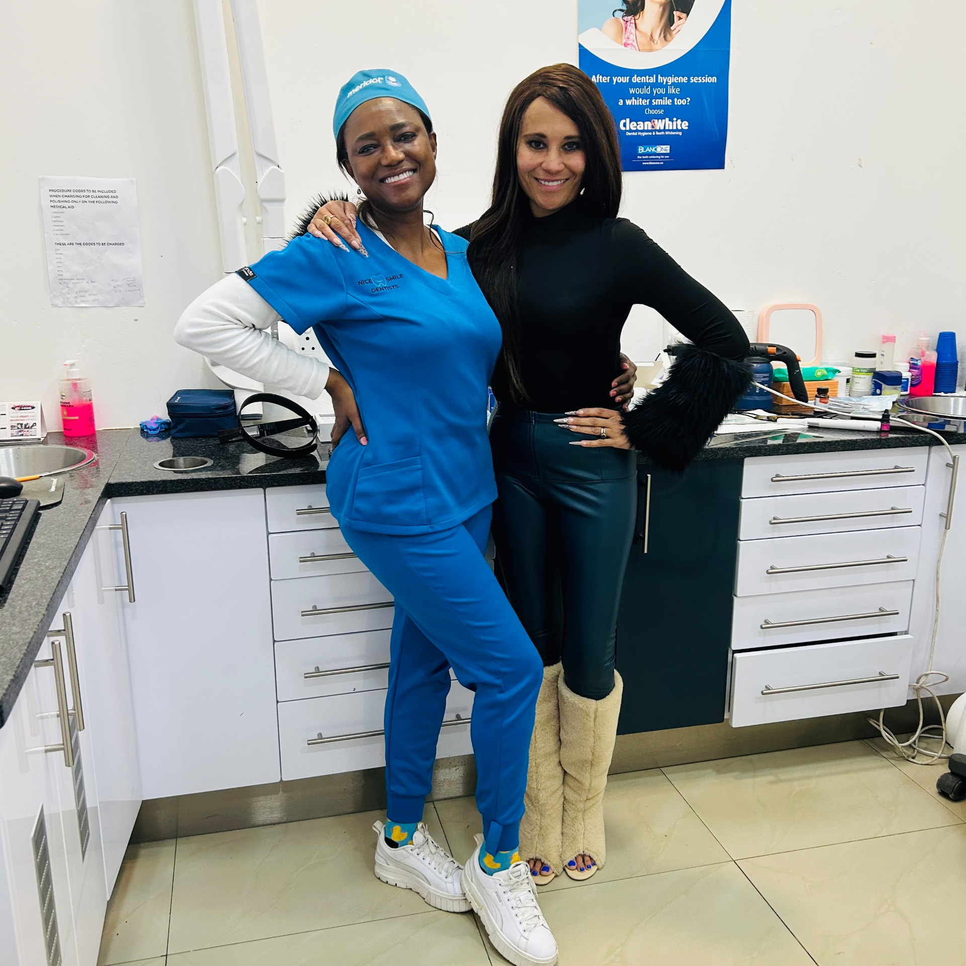 Cass standing with her dentist in the surgery, both smiling